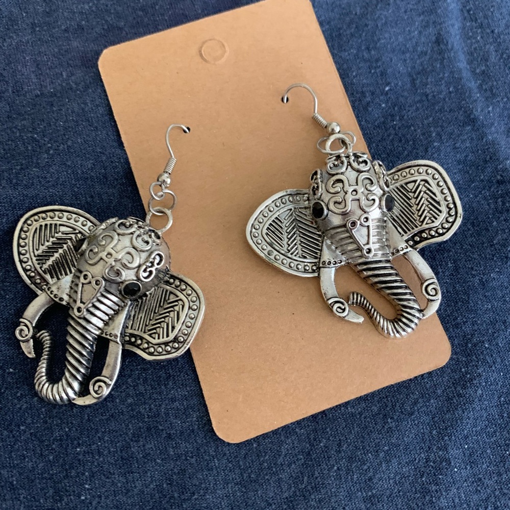 Silver tone elephant earrings. Hook style ear wire.